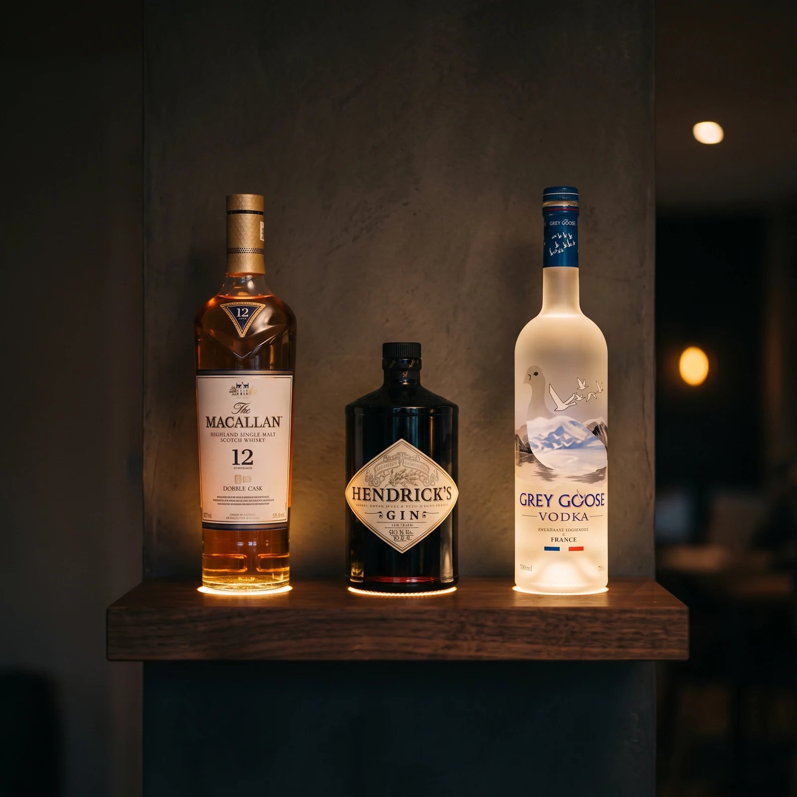 Three bottles on a home shelf, each lit from below